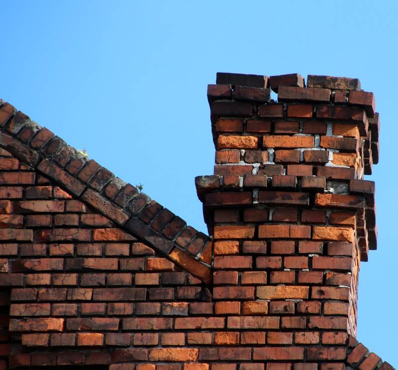 Damaged chimney on an Broadview home showing cracks and missing mortar